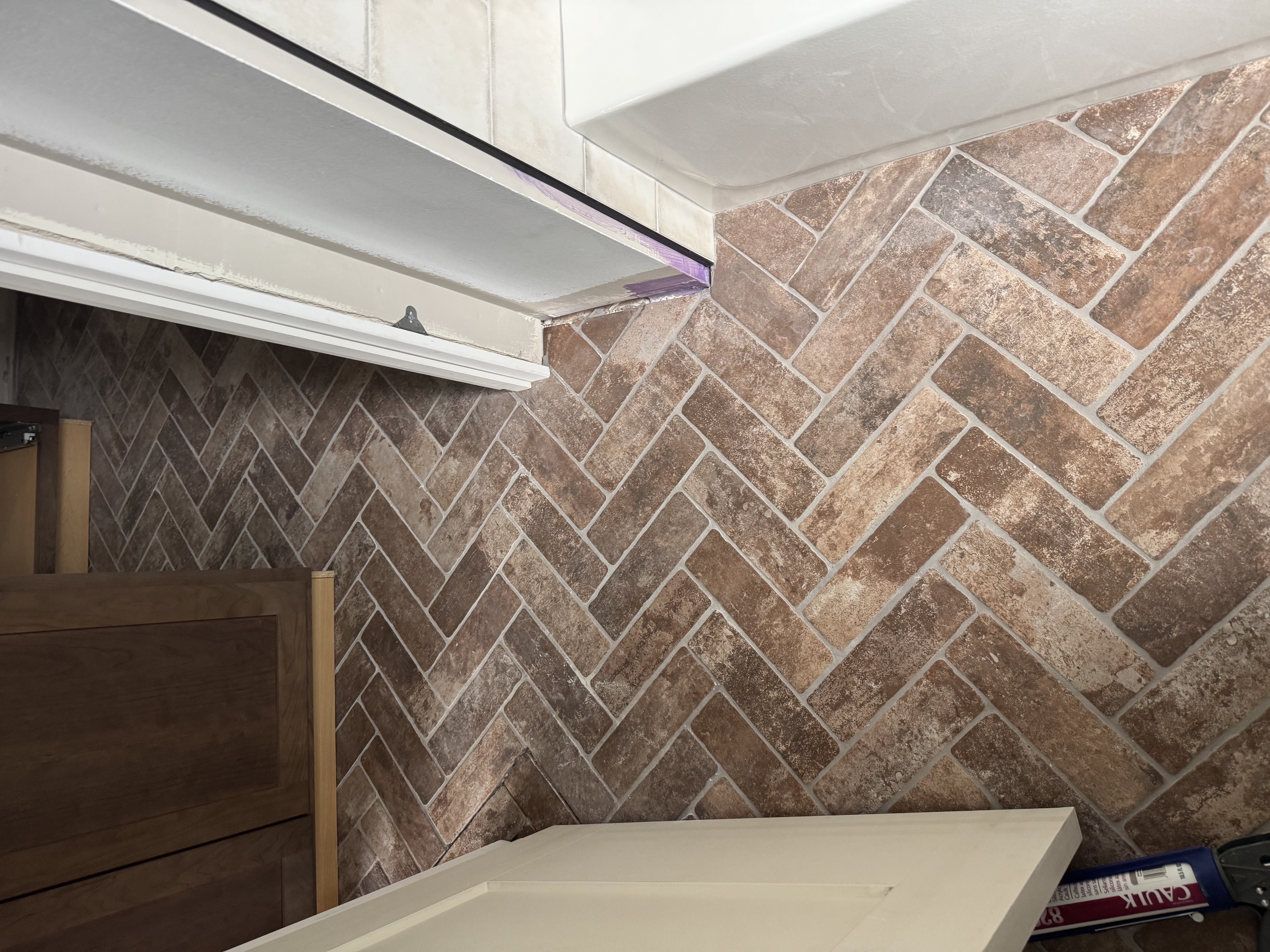 Herringbone brick tile bathroom floor installation in St. Louis