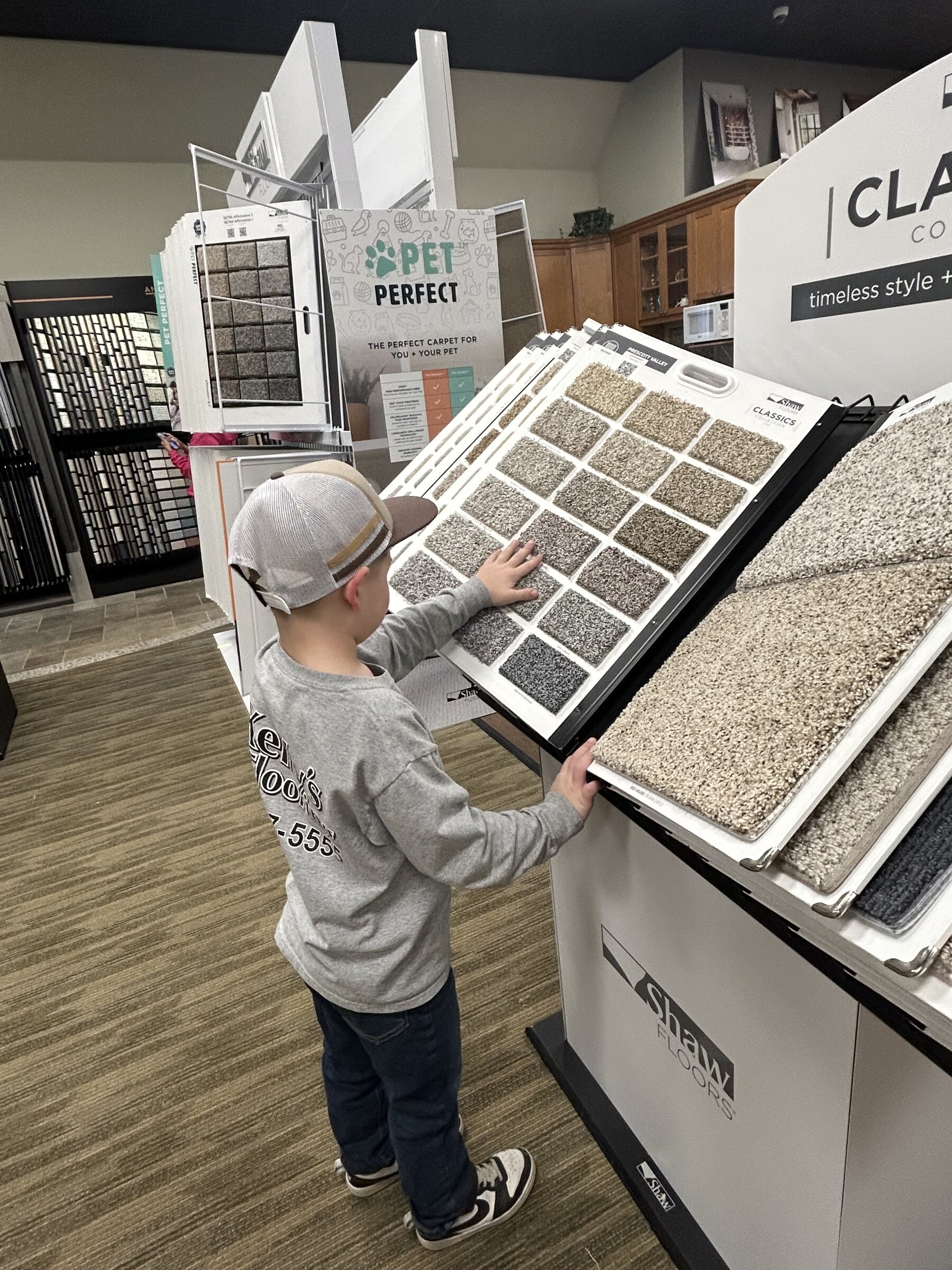 Browsing Shaw Floors carpet samples at Kelly's Flooring showroom