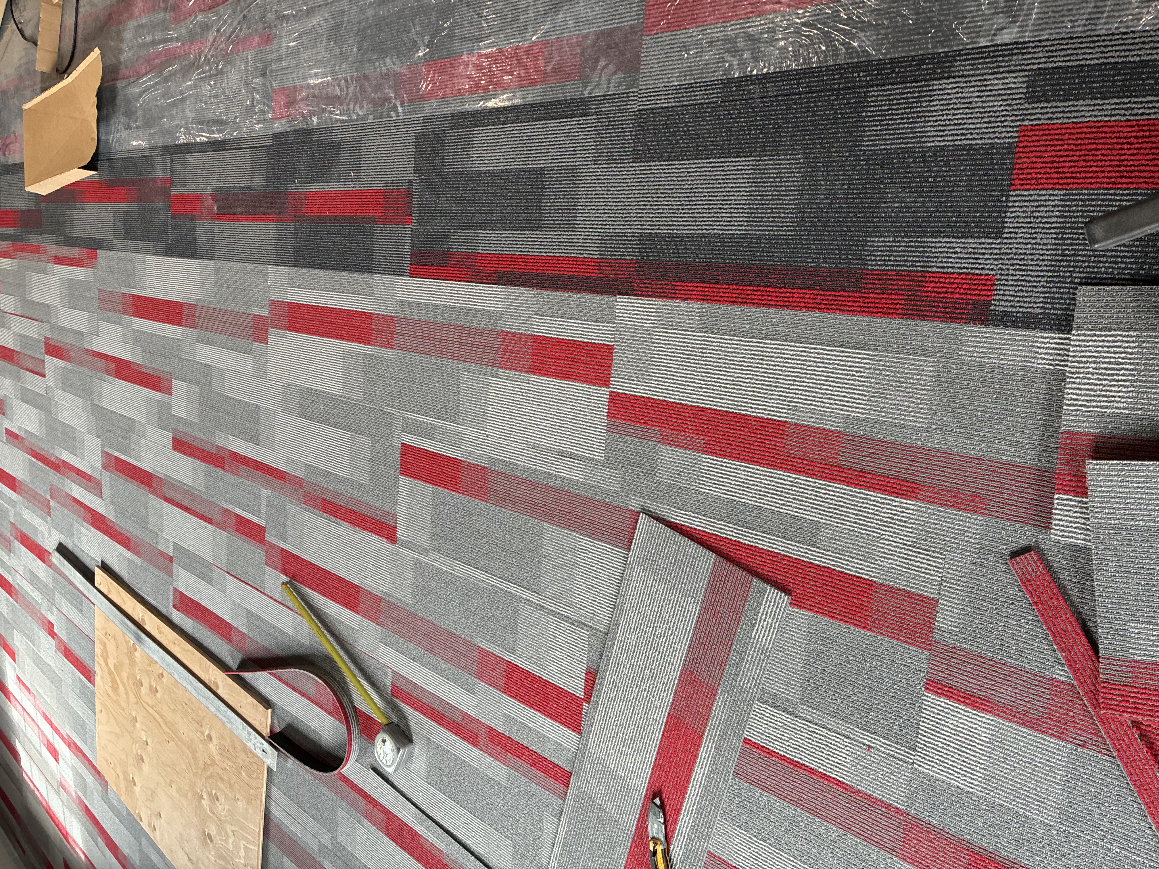 Commercial carpet tile cutting and fitting during office flooring installation