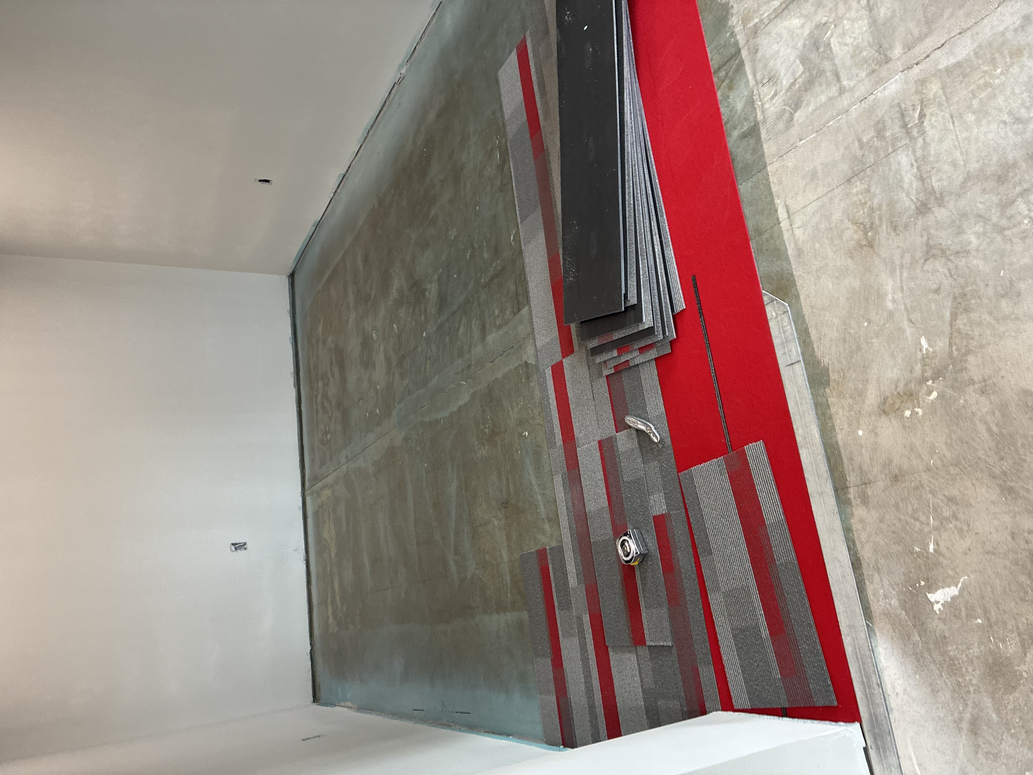 Commercial carpet tile layout with glue-down adhesive on concrete subfloor