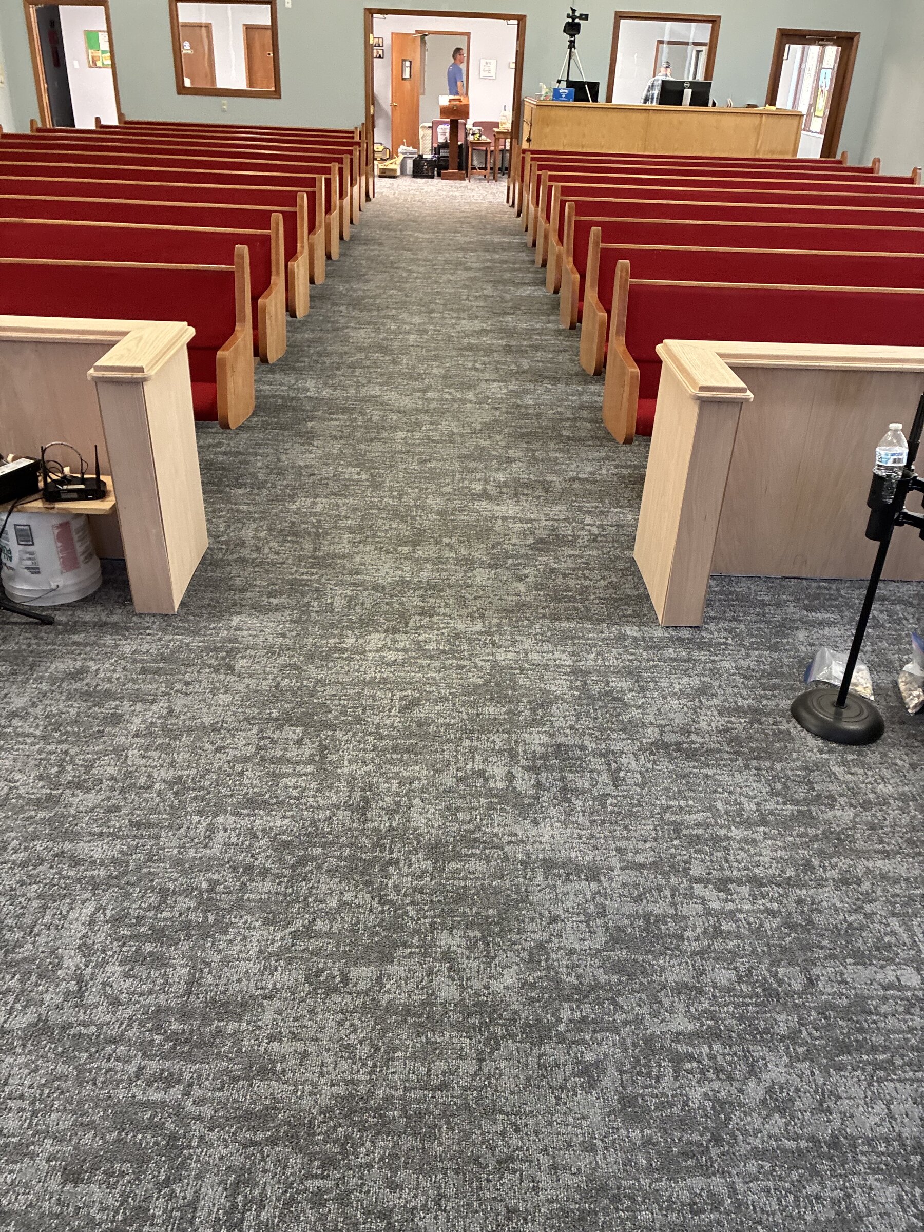 Grey carpet aisle between church pews
