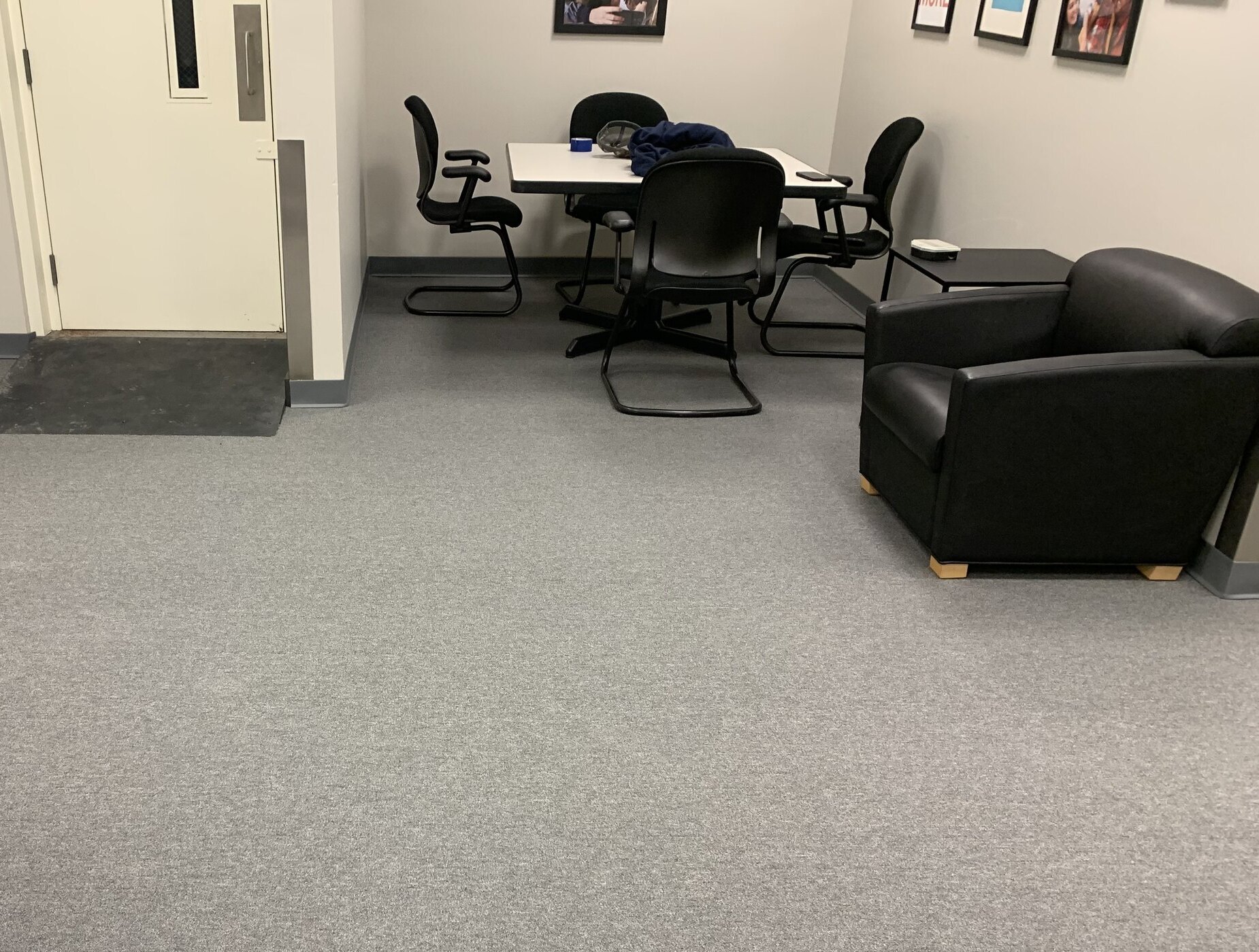 Grey commercial carpet in office meeting room with chairs and table