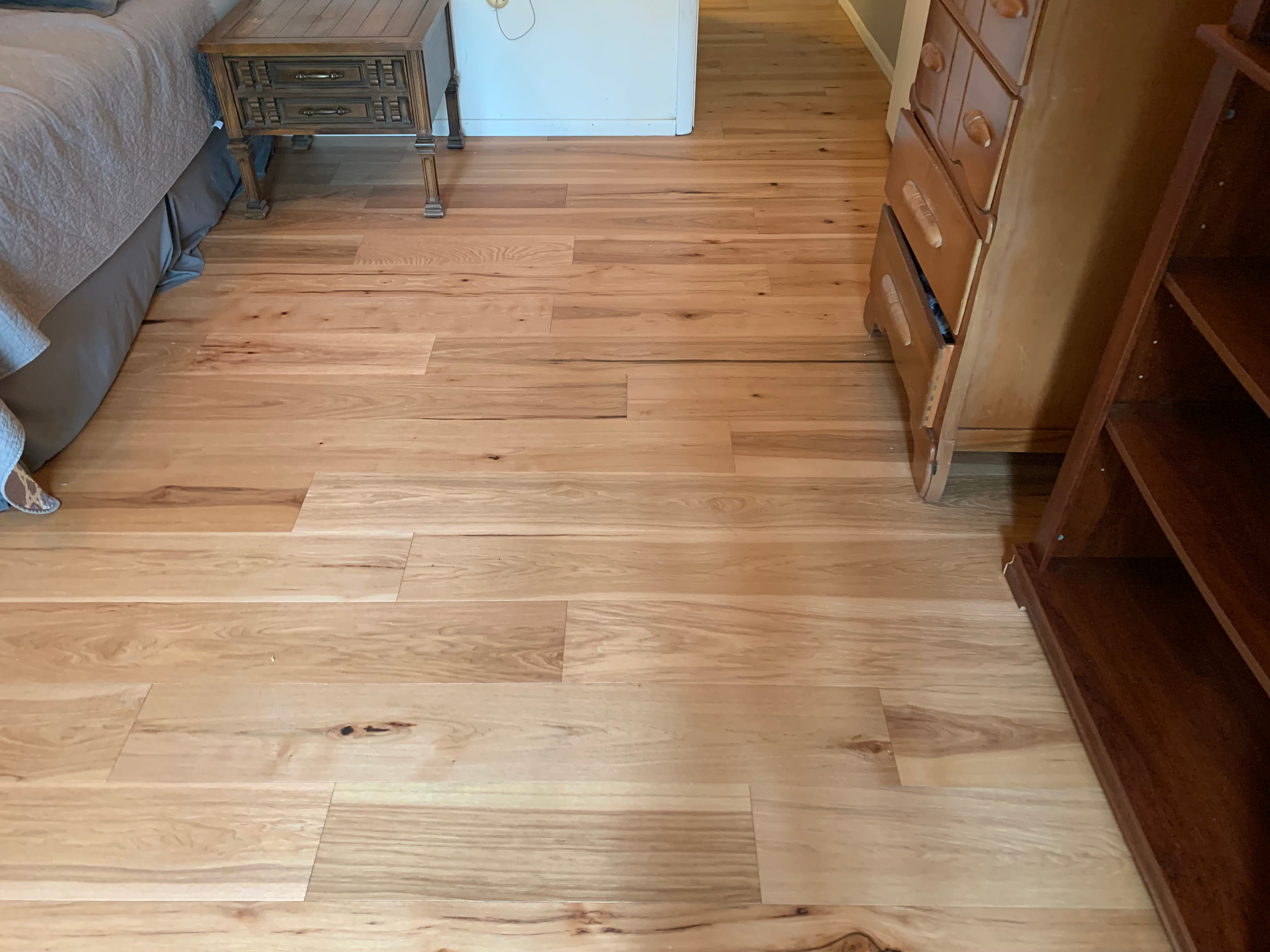 Wide plank natural hardwood flooring in bedroom