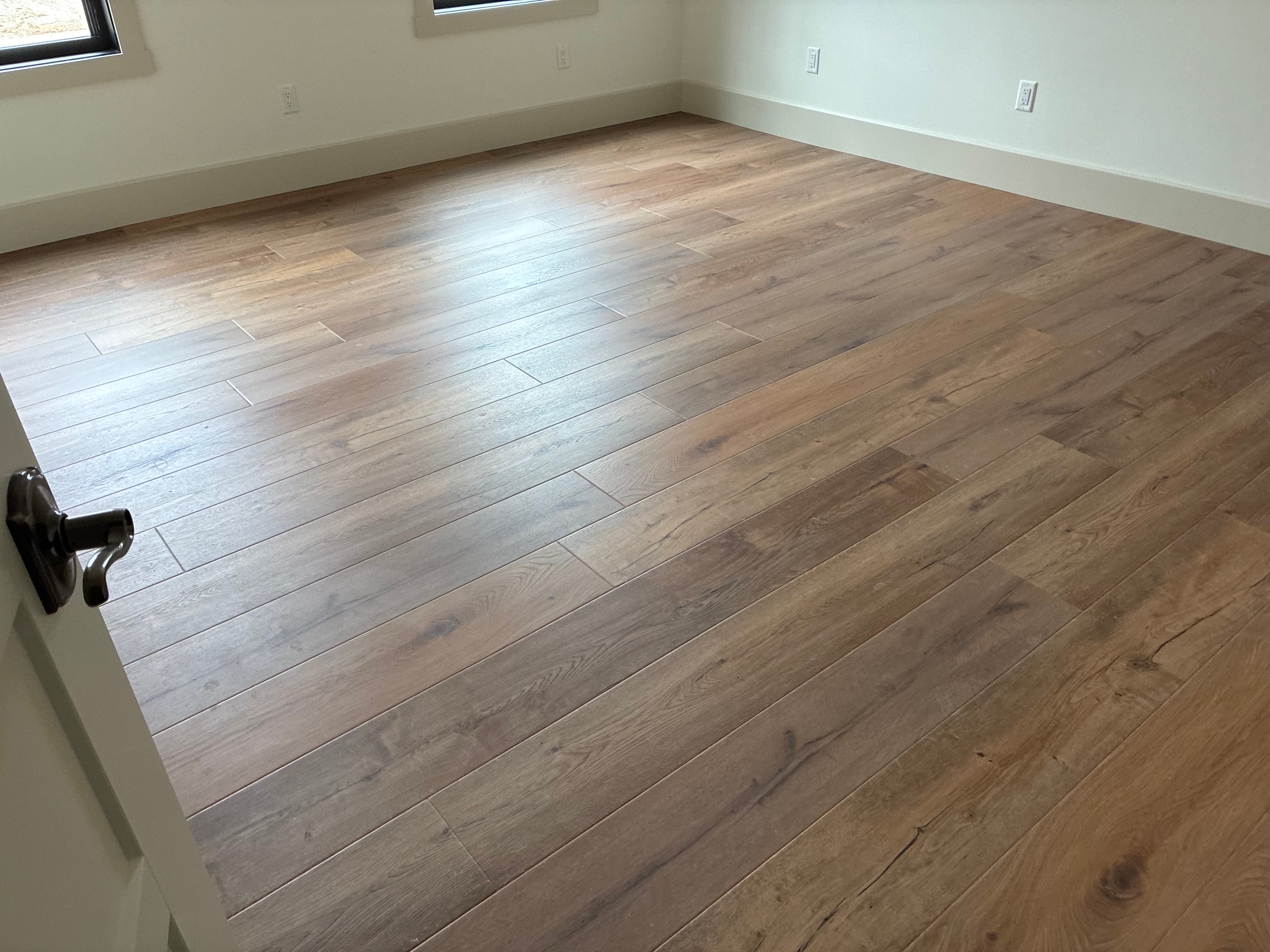New hardwood flooring installation in empty room