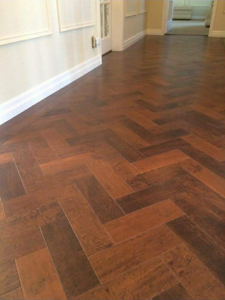 Herringbone wood-look tile installed in a High Ridge home hallway