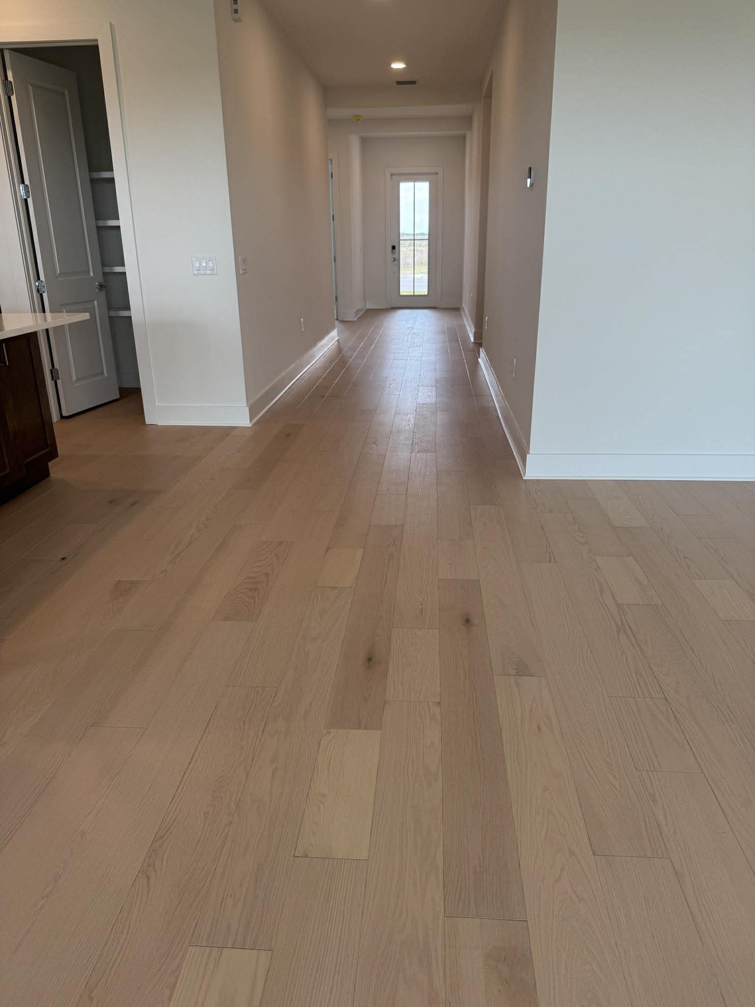 Light natural hardwood in new construction hallway