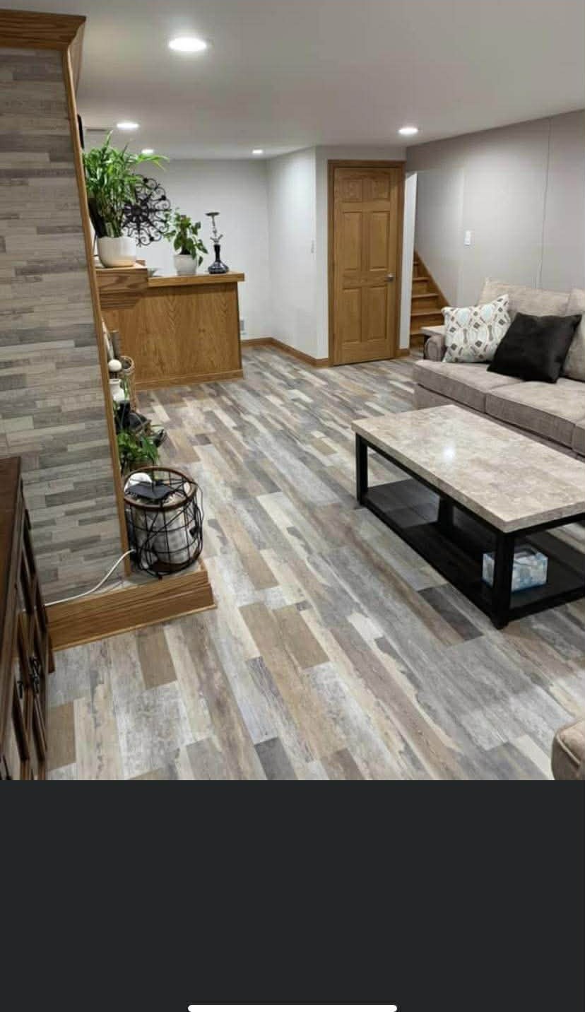 Luxury vinyl plank installed in an Arnold finished basement family room