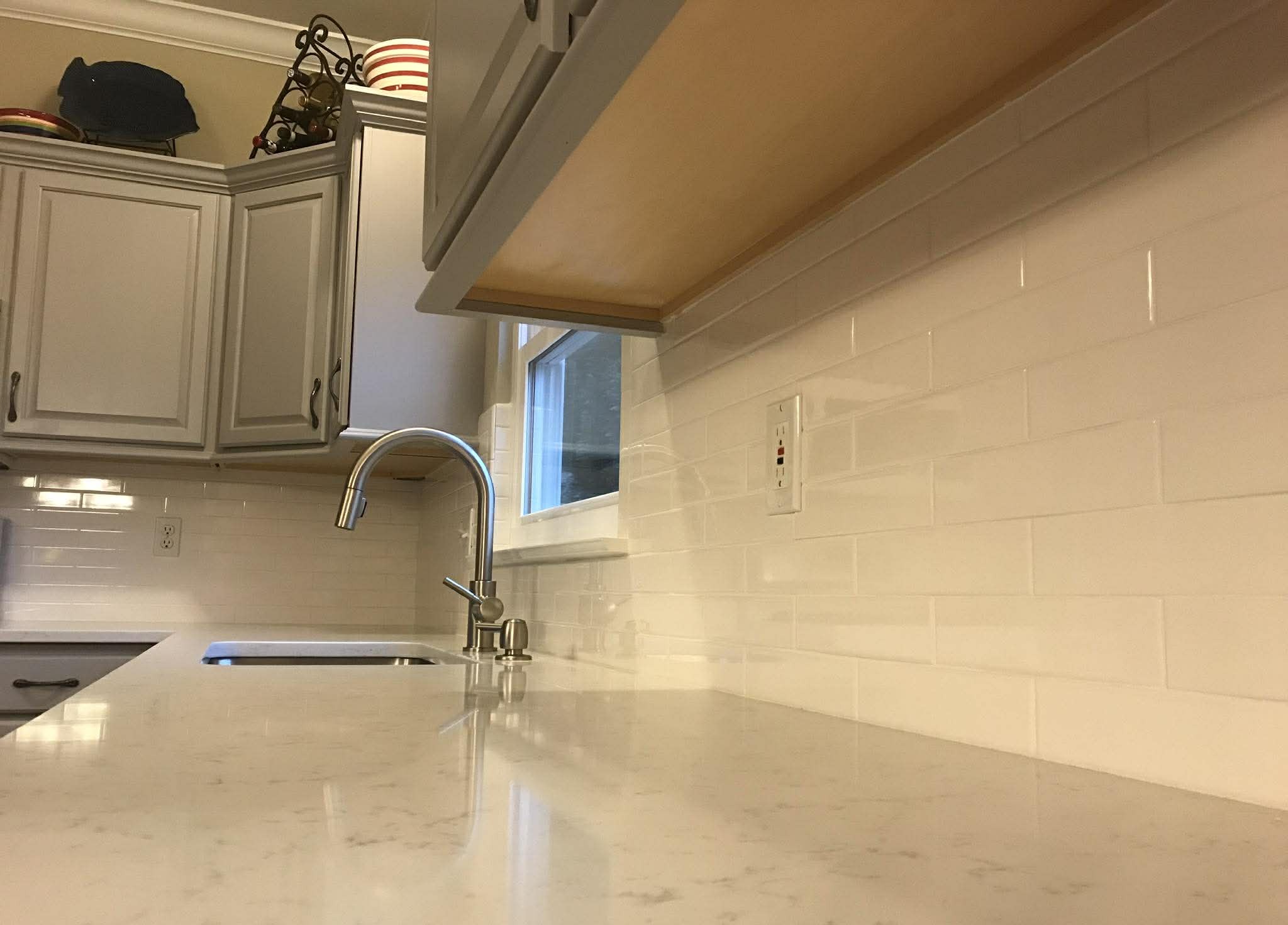 Subway tile backsplash and countertop installation in kitchen