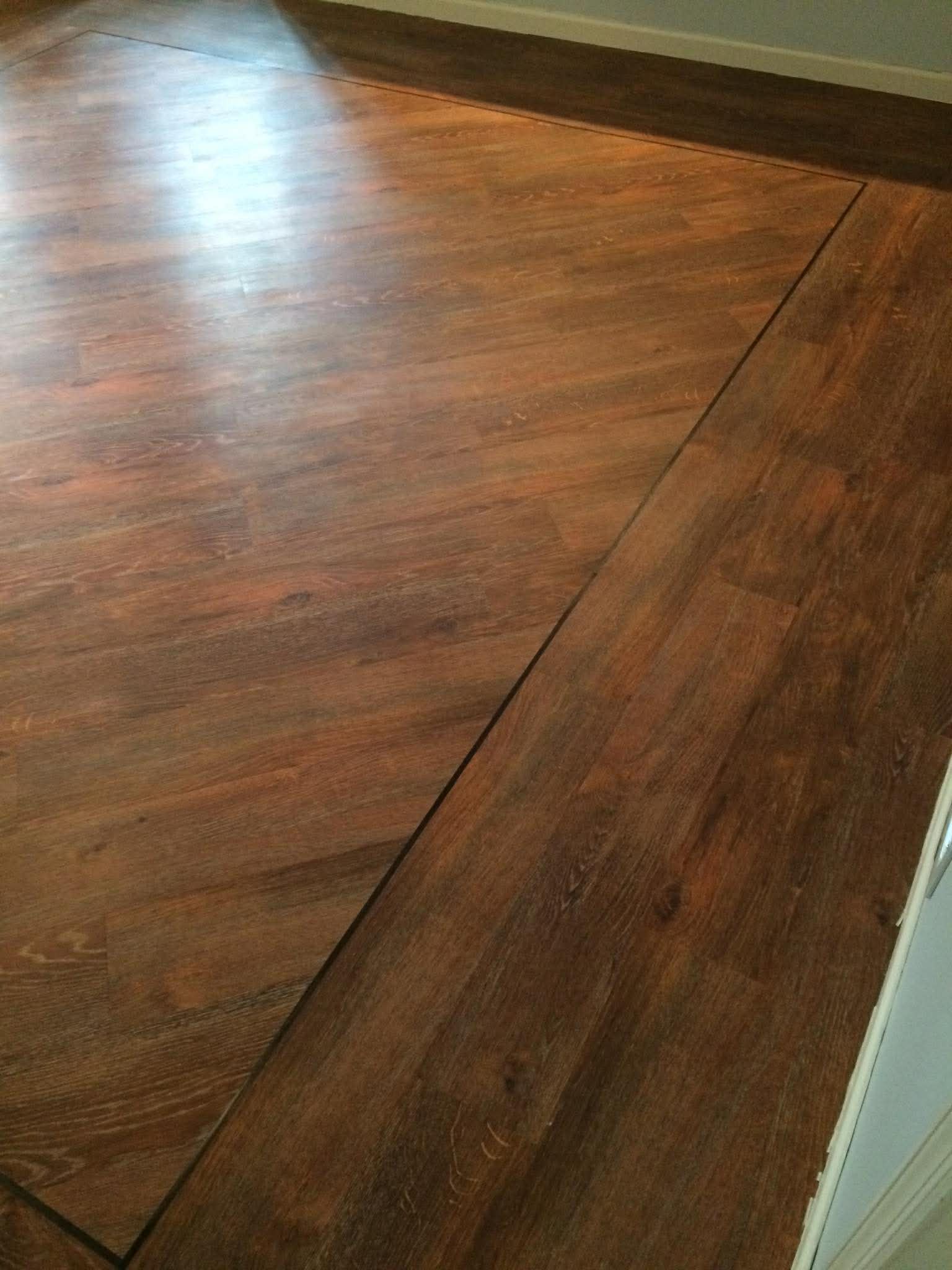 Dark wood-look flooring with diagonal direction change detail