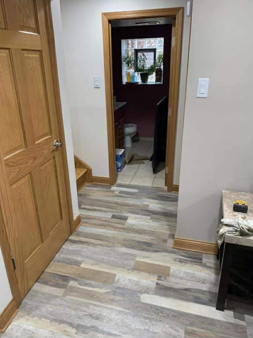 Multicolor gray luxury vinyl plank in entryway hallway