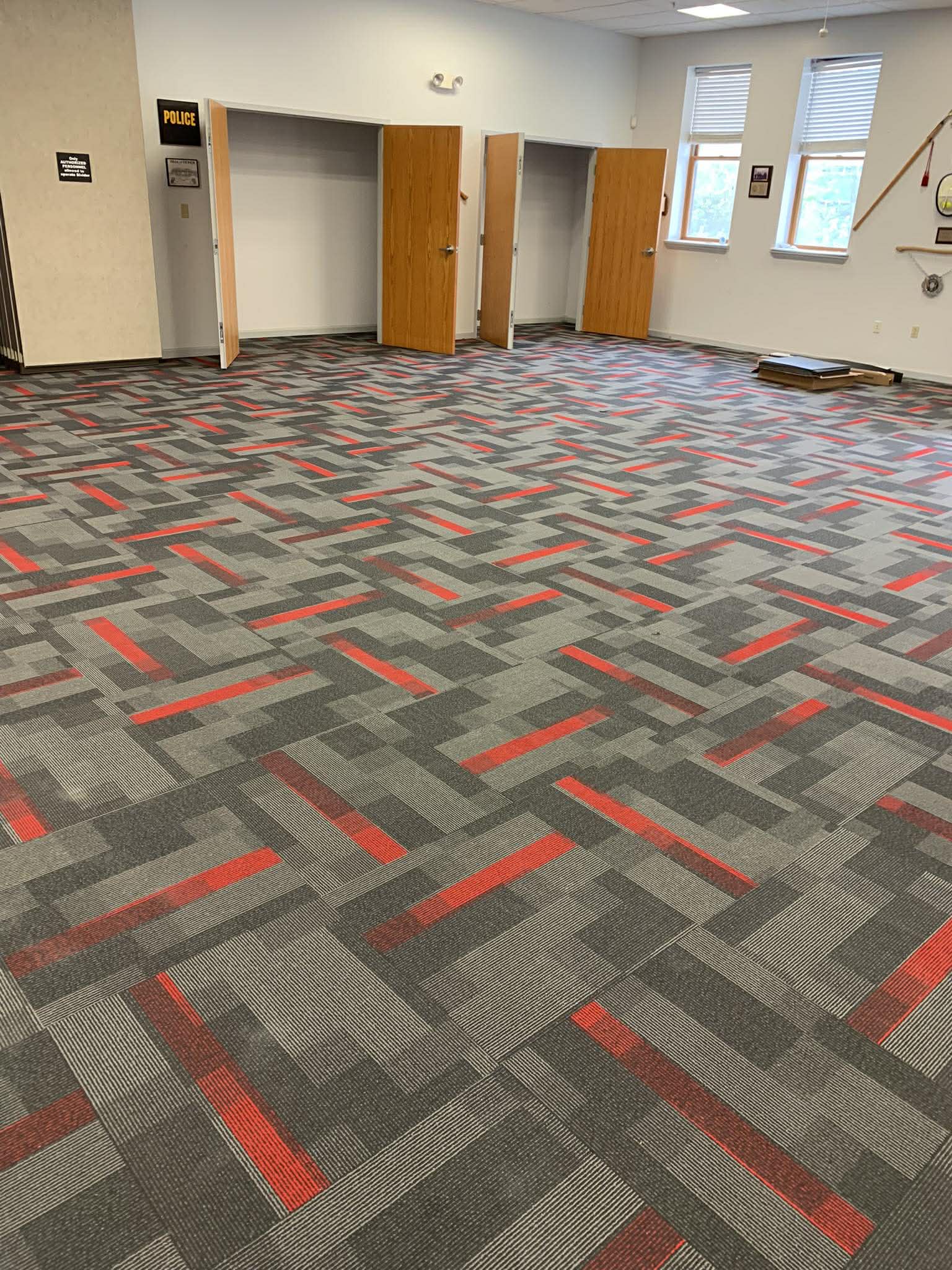 Commercial carpet tile installation with gray and red pattern
