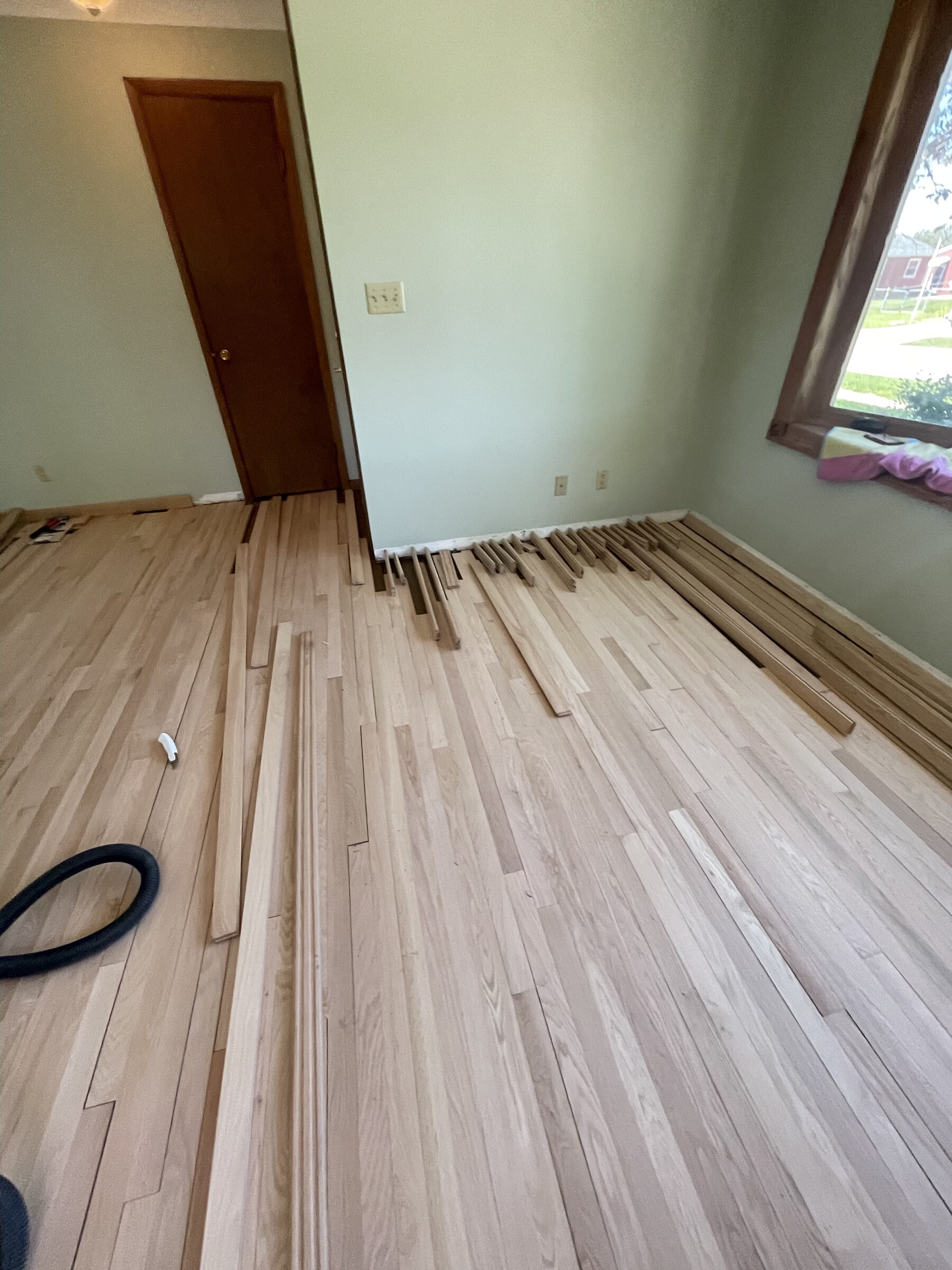 Hardwood plank installation in progress at a St. Louis area home