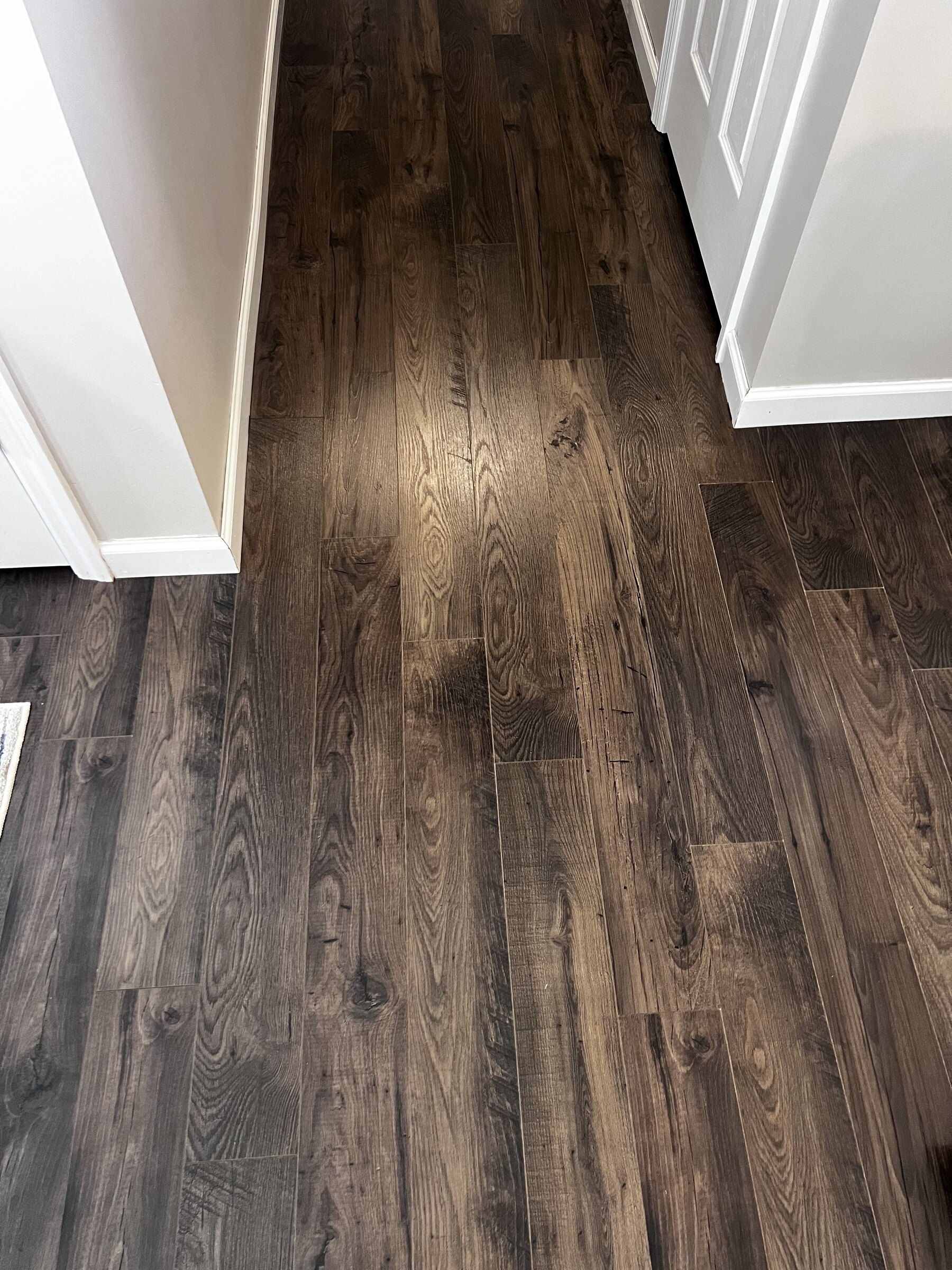 Dark oak laminate flooring through doorway transition