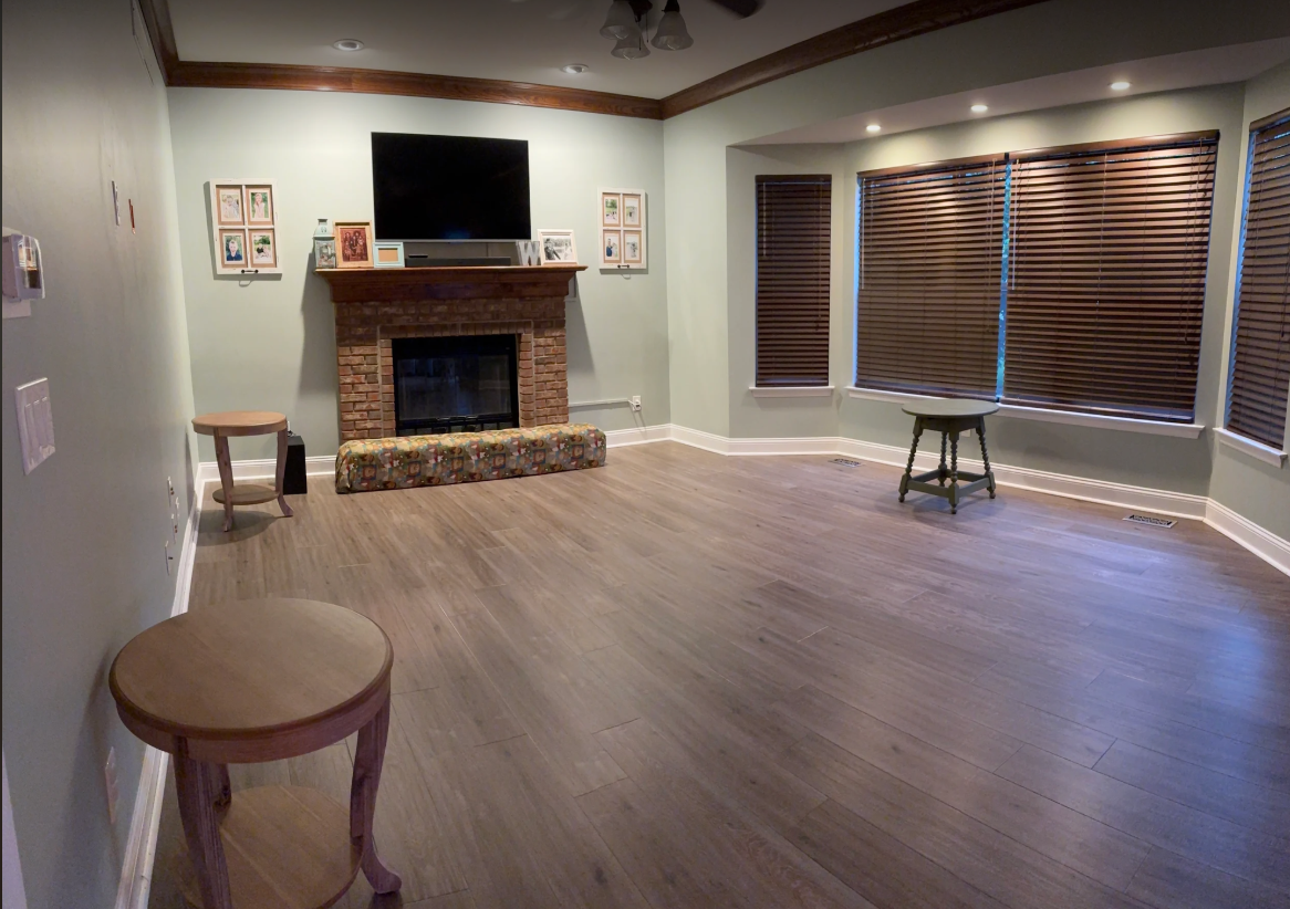 Karndean Art Select Tweed Oak luxury vinyl plank flooring in living room with fireplace