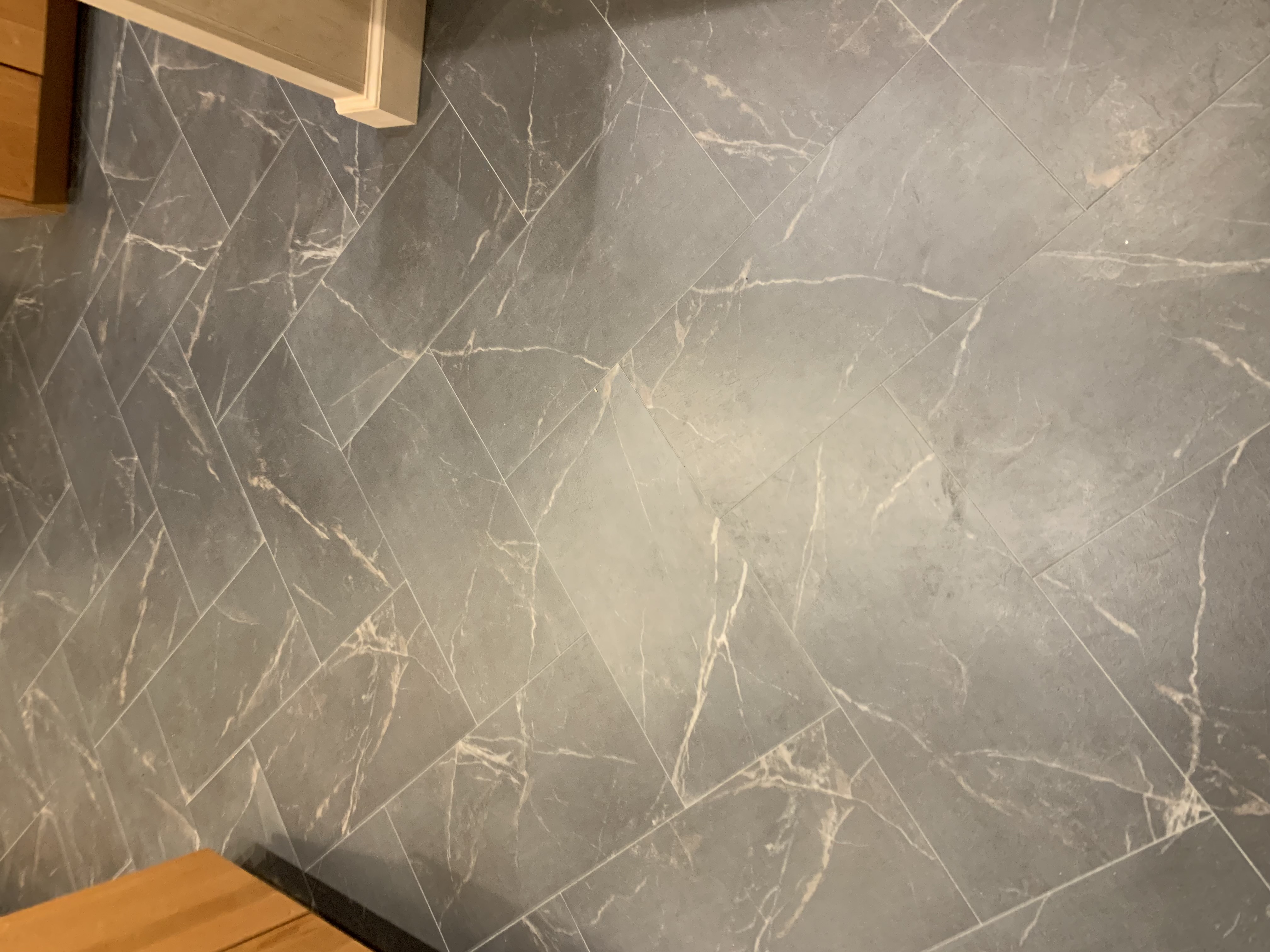 Close-up of Mannington Baltic Stone Storm luxury vinyl tile in herringbone pattern