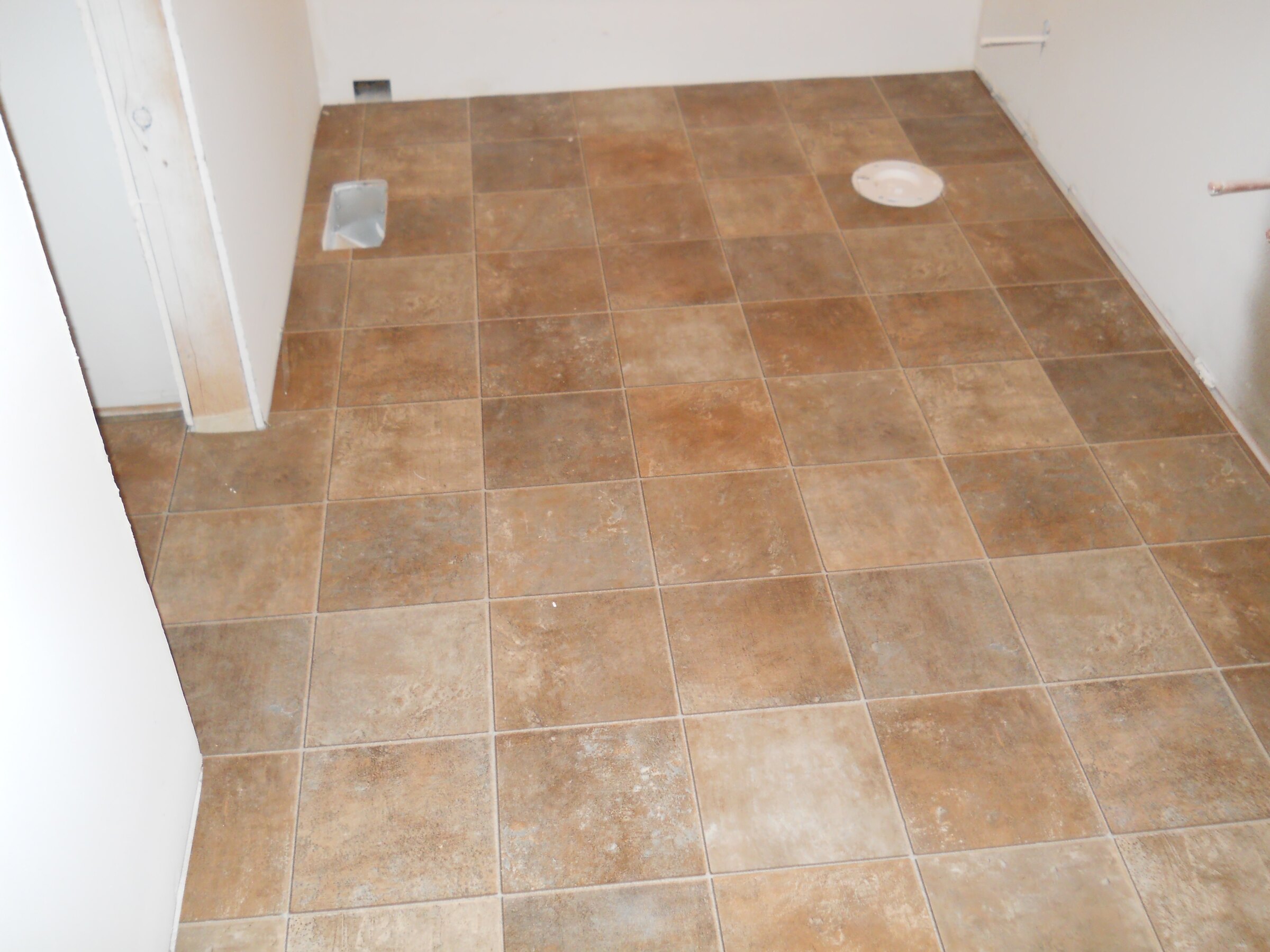 Tan tile-look sheet vinyl flooring in laundry room