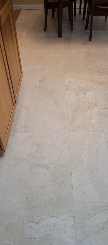 Large-format natural stone-look tile flooring in dining area