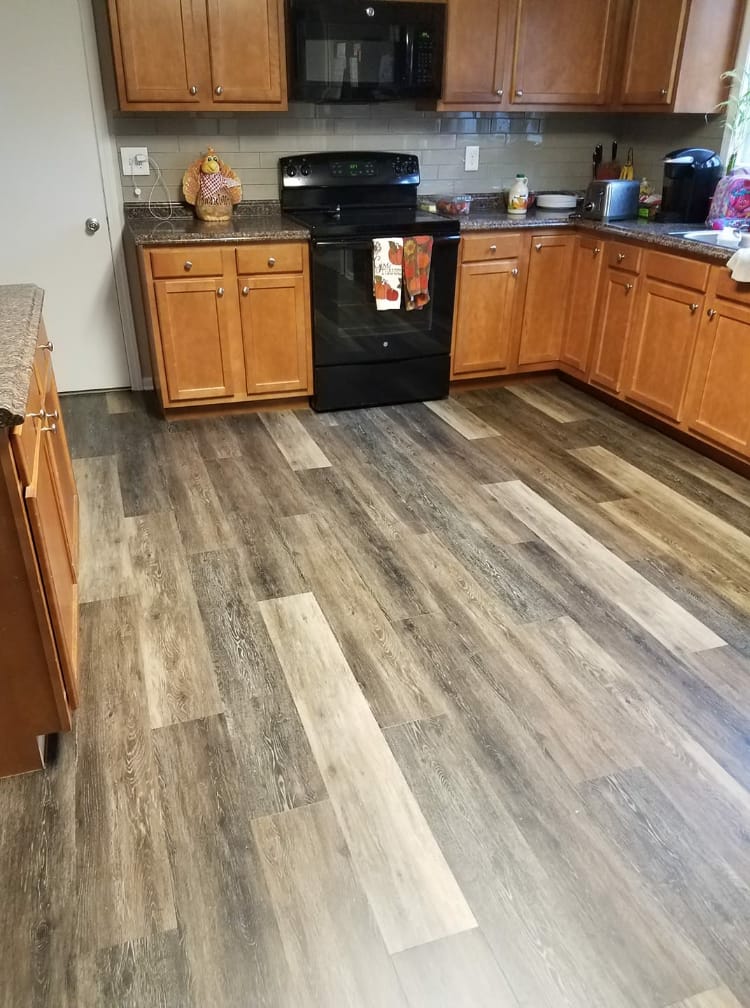 Luxury vinyl plank kitchen flooring installation with oak cabinets by Kelly's Flooring in St. Louis