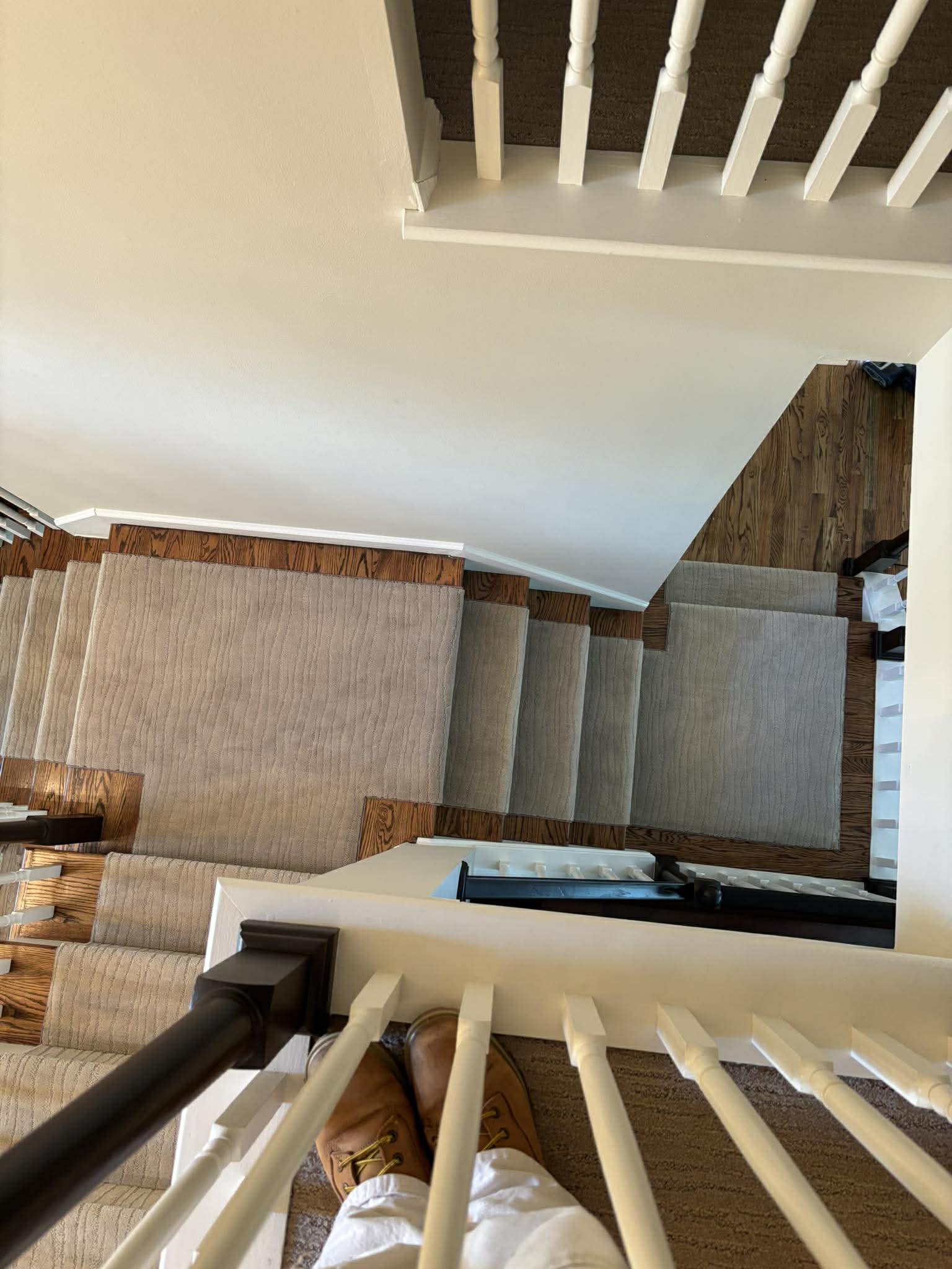 Neutral beige carpet on stairs with exposed wood edges