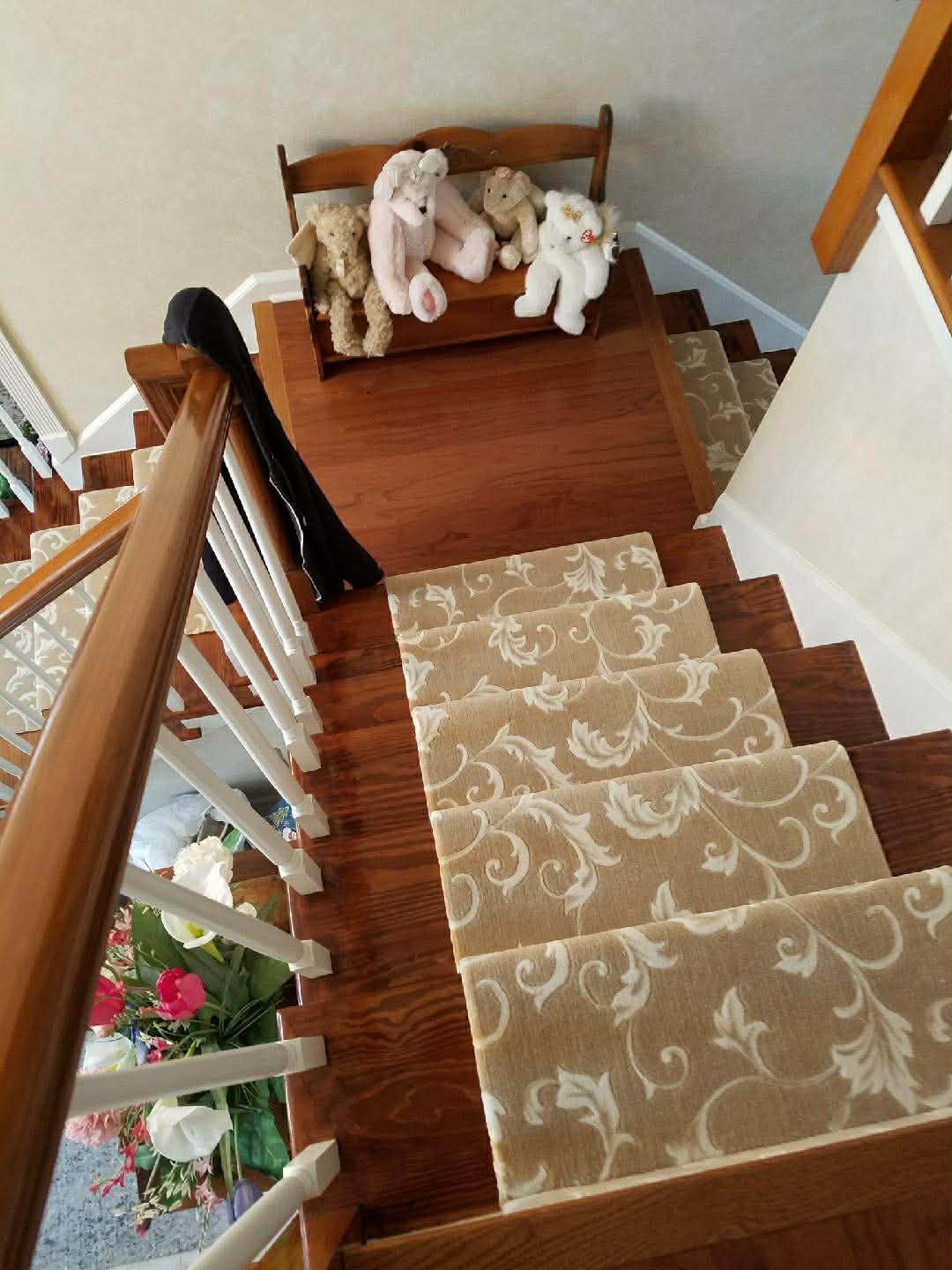 Beige floral scroll carpet on stairs viewed from above