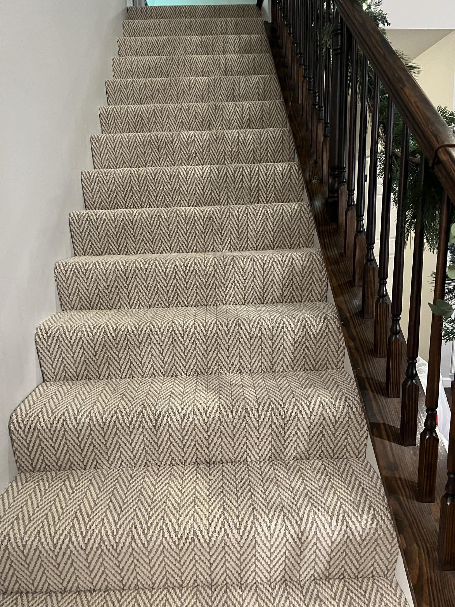 Gray herringbone carpet on stairs