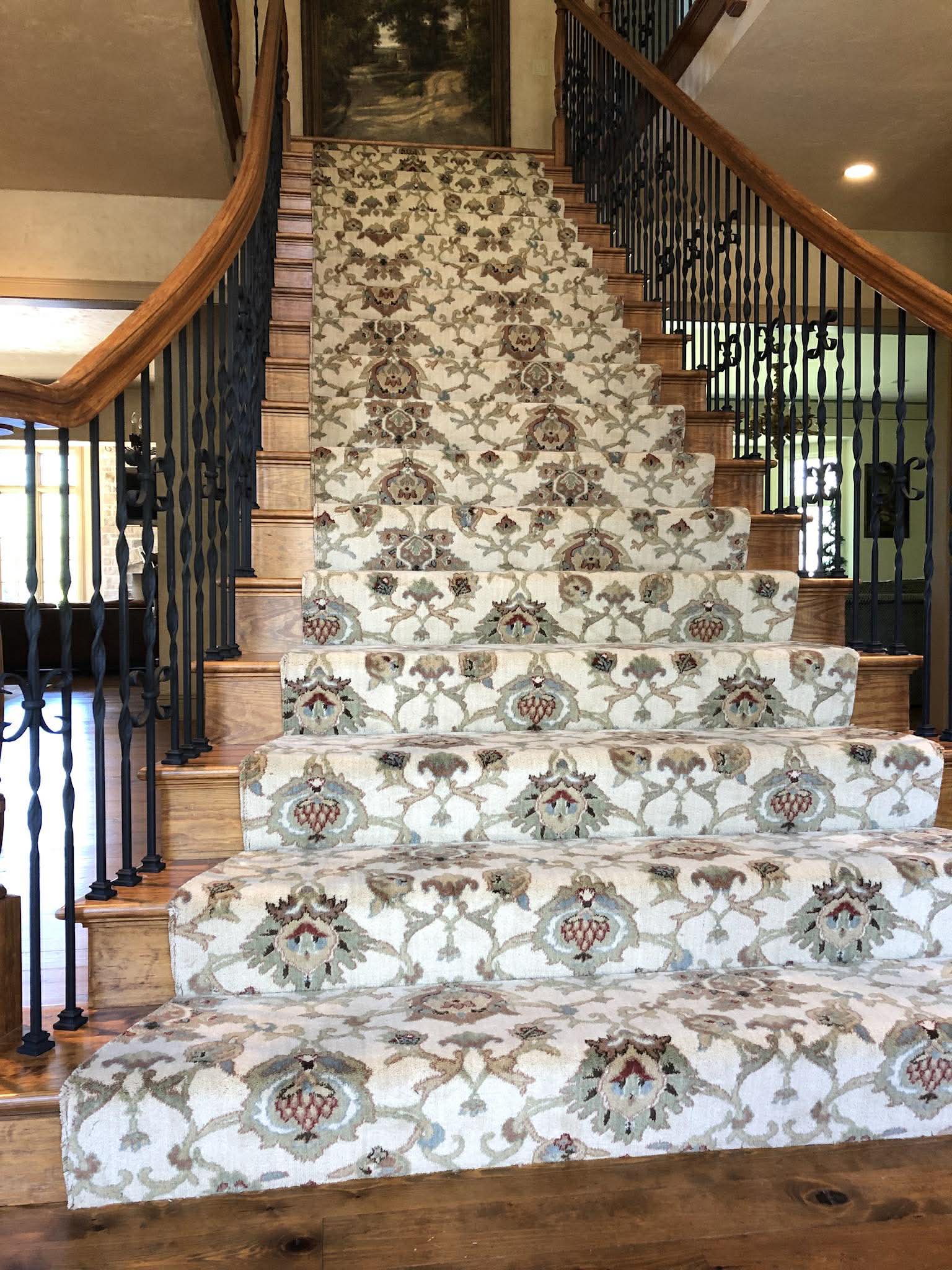 Ornate cream floral carpet on grand staircase